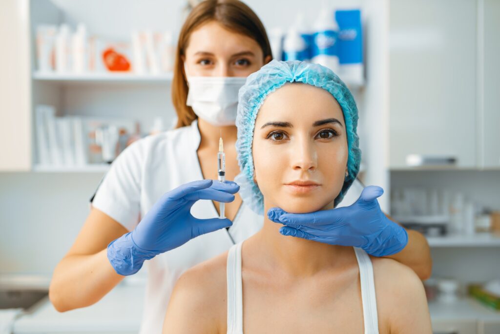 cosmetician holds syringe with injection of botox